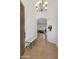 Bright foyer with tile flooring leading to a living room with an open archway and bench seating at 800 W Palo Brea Dr, Litchfield Park, AZ 85340