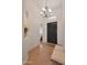 Welcoming foyer with neutral tile flooring, bench seating, and decorative chandelier at 800 W Palo Brea Dr, Litchfield Park, AZ 85340