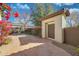 A landscaped walkway leads to a courtyard entrance with an access door and desert flowers at 800 W Palo Brea Dr, Litchfield Park, AZ 85340