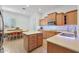 Spacious kitchen featuring custom cabinets, a central island, and a stainless-steel appliances at 800 W Palo Brea Dr, Litchfield Park, AZ 85340