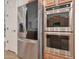 Modern kitchen featuring stainless steel refrigerator and double wall ovens at 800 W Palo Brea Dr, Litchfield Park, AZ 85340