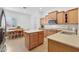 Open kitchen featuring wooden cabinets, an island, and stainless steel appliances at 800 W Palo Brea Dr, Litchfield Park, AZ 85340