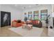 Bright living room with neutral walls, tan tile floor, and stylish contemporary furnishings at 800 W Palo Brea Dr, Litchfield Park, AZ 85340