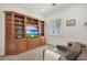 Cozy living room features custom built-ins for media and window with views of the front yard at 800 W Palo Brea Dr, Litchfield Park, AZ 85340