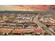 Overhead shot of a desert community featuring tidy homes, palm trees, and arterial roadways at 8012 E Monte Ave, Mesa, AZ 85209