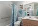 Cozy bathroom featuring a shower/tub combo with a floral curtain and a vanity with a sink and mirror at 8012 E Monte Ave, Mesa, AZ 85209