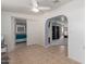 Bright bonus room featuring neutral tile flooring and a view into adjacent bedrooms at 8012 E Monte Ave, Mesa, AZ 85209