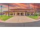 Exterior shot of the community clubhouse with inviting entrance and beautiful desert landscaping at 8012 E Monte Ave, Mesa, AZ 85209