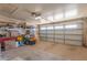 Spacious garage with shelving, storage boxes, and an automatic door for convenient parking and storage solutions at 8012 E Monte Ave, Mesa, AZ 85209