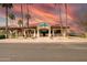 Exterior view of the Golf Shop with desert landscaping and tall palm trees under a stunning colorful sky at 8012 E Monte Ave, Mesa, AZ 85209