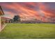 Expansive green lawn with mature trees, showcasing the well-maintained grounds of the community at 8012 E Monte Ave, Mesa, AZ 85209