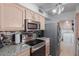 Well-lit kitchen featuring stainless steel appliances, granite countertops, and tile backsplash at 8012 E Monte Ave, Mesa, AZ 85209