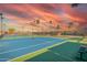 Enjoy a match on the well-maintained community tennis court, framed by the beauty of the sunset at 8012 E Monte Ave, Mesa, AZ 85209