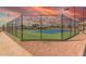 Well-maintained tennis court with new surface and lighting for evening play, surrounded by secure fencing at 8012 E Monte Ave, Mesa, AZ 85209