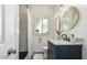 Bathroom featuring a walk-in shower with tile surround, modern fixtures, and a vanity with storage at 809 N 11Th Ave, Phoenix, AZ 85007