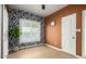 Bedroom with wood floors, a window with blinds, decorative wallpaper, and access to the closet and the bathroom at 809 N 11Th Ave, Phoenix, AZ 85007