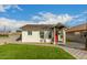 Charming home with a landscaped front yard, a red front door, and a driveway leading to the garage at 809 N 11Th Ave, Phoenix, AZ 85007