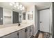 Well-lit bathroom featuring a neutral countertop, updated cabinets, and a framed mirror at 8344 N 21St Dr # I105, Phoenix, AZ 85021