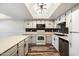 Modern kitchen featuring stainless steel appliances, white cabinetry, and tile backsplash, for a sleek design at 8344 N 21St Dr # I105, Phoenix, AZ 85021