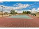 Well-maintained community tennis court with net, fencing and desert landscaping under a partly cloudy sky at 8344 N 21St Dr # I105, Phoenix, AZ 85021