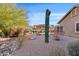 Spacious backyard with desert landscaping featuring a gazebo, native plants, and desert rock at 8499 E Jumping Cholla Dr, Gold Canyon, AZ 85118