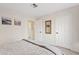 Cozy bedroom with neutral walls, carpeted floors, a mirror, and a door to another room at 8499 E Jumping Cholla Dr, Gold Canyon, AZ 85118