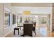 Bright dining room with a large wooden table and windows providing natural light at 8499 E Jumping Cholla Dr, Gold Canyon, AZ 85118