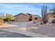 Charming single-story home featuring desert landscaping and an attached two-car garage at 8499 E Jumping Cholla Dr, Gold Canyon, AZ 85118