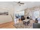 Spacious living room features a stone fireplace, ceiling fan, and hardwood floors at 8499 E Jumping Cholla Dr, Gold Canyon, AZ 85118