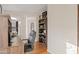 Home office featuring a wooden desk, shelving, and hardwood floors at 8499 E Jumping Cholla Dr, Gold Canyon, AZ 85118