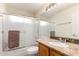 Bathroom featuring a vanity, framed mirror, granite countertops, and shower with glass doors at 911 W Sandra Ter, Phoenix, AZ 85023