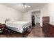 Neutral bedroom featuring hardwood floors and comfortable furnishings at 911 W Sandra Ter, Phoenix, AZ 85023