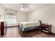 Bright bedroom featuring wood flooring, large window, and ceiling fan at 911 W Sandra Ter, Phoenix, AZ 85023