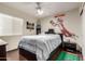 Comfortable bedroom with ceiling fan, warm wood floors and sports themed decor at 911 W Sandra Ter, Phoenix, AZ 85023