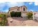 View of two-story home with desert landscaping, rock features, and green shrubs at 911 W Sandra Ter, Phoenix, AZ 85023