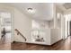 Upstairs hallway with wood floors, overlooking a home gym and an open, bright floor plan at 911 W Sandra Ter, Phoenix, AZ 85023