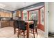 Eat-in kitchen with an island, tile flooring, and natural light from a bay window at 911 W Sandra Ter, Phoenix, AZ 85023