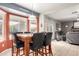 Eat-in kitchen with a view of the living room, tile flooring, and natural light from a bay window at 911 W Sandra Ter, Phoenix, AZ 85023