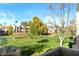 Lush backyard with well-manicured lawn and mature trees, offers a serene view from the balcony at 9270 E Mission Ln # 211, Scottsdale, AZ 85258