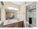 Dual sink vanity and a glass-enclosed shower at 9270 E Mission Ln # 211, Scottsdale, AZ 85258