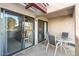 Relaxing covered patio area features sliding glass doors and outdoor seating with views at 9270 E Mission Ln # 211, Scottsdale, AZ 85258