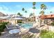 Resort-style pool area with lush landscaping, seating, and shade, perfect for leisure at 9270 E Mission Ln # 211, Scottsdale, AZ 85258