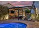 Outdoor entertainment area with a pool and pergola, with a bar and TV at 928 S San Joaquin Ct, Gilbert, AZ 85296