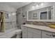 Well-lit bathroom with a shower-over-tub featuring tile surround, and modern vanity with tiled backsplash at 928 S San Joaquin Ct, Gilbert, AZ 85296