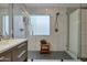 Modern bathroom with a glass-enclosed shower, marble-tiled walls, and a floating vanity at 928 S San Joaquin Ct, Gilbert, AZ 85296