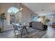 Bright dining area featuring vaulted ceilings, a large window, and modern light fixtures at 928 S San Joaquin Ct, Gilbert, AZ 85296