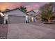 Charming single-story home with a well-maintained lawn, a two-car garage, and manicured landscaping at dusk at 928 S San Joaquin Ct, Gilbert, AZ 85296