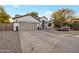 Charming single-story home with a well-maintained lawn, a two-car garage, and manicured landscaping at 928 S San Joaquin Ct, Gilbert, AZ 85296