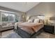 Relaxing bedroom features a plush bed, sitting area, and a bay window with natural light at 928 S San Joaquin Ct, Gilbert, AZ 85296