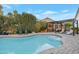 Inviting pool with a Baja step and a covered lounge area, perfect for outdoor relaxation and entertainment at 928 S San Joaquin Ct, Gilbert, AZ 85296